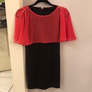 Little black dress with attached sheer coral cape. Gold button detail XS